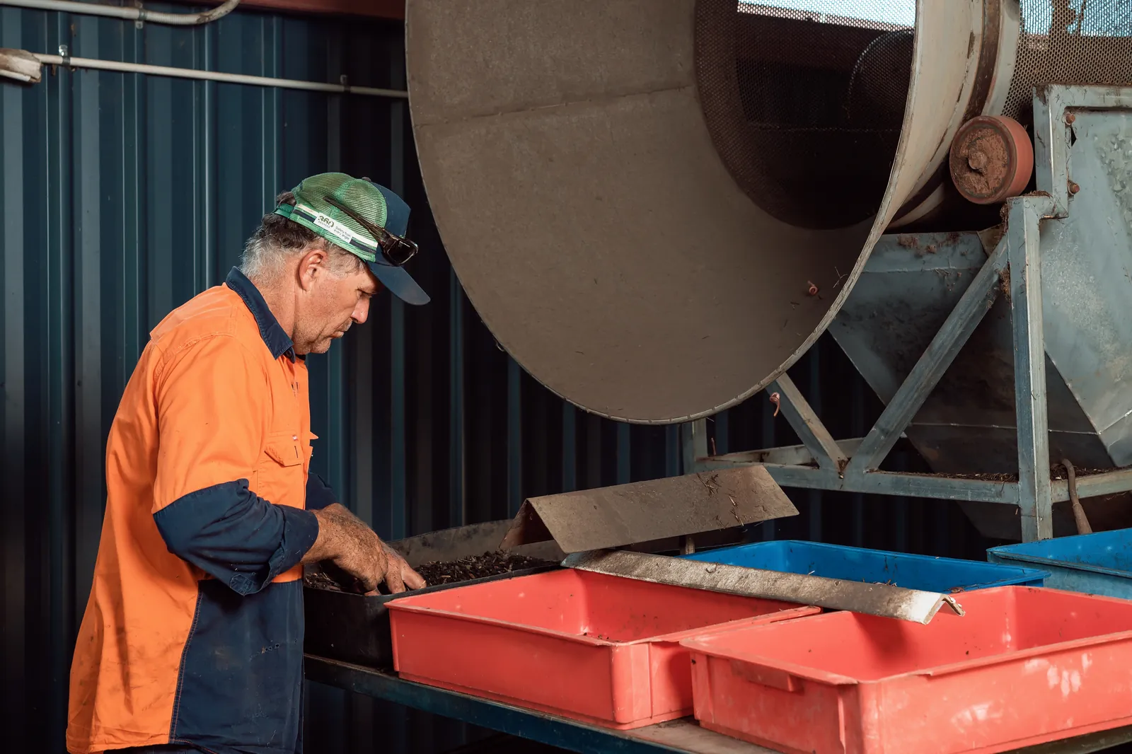 A team member moving crates of castings at the farm